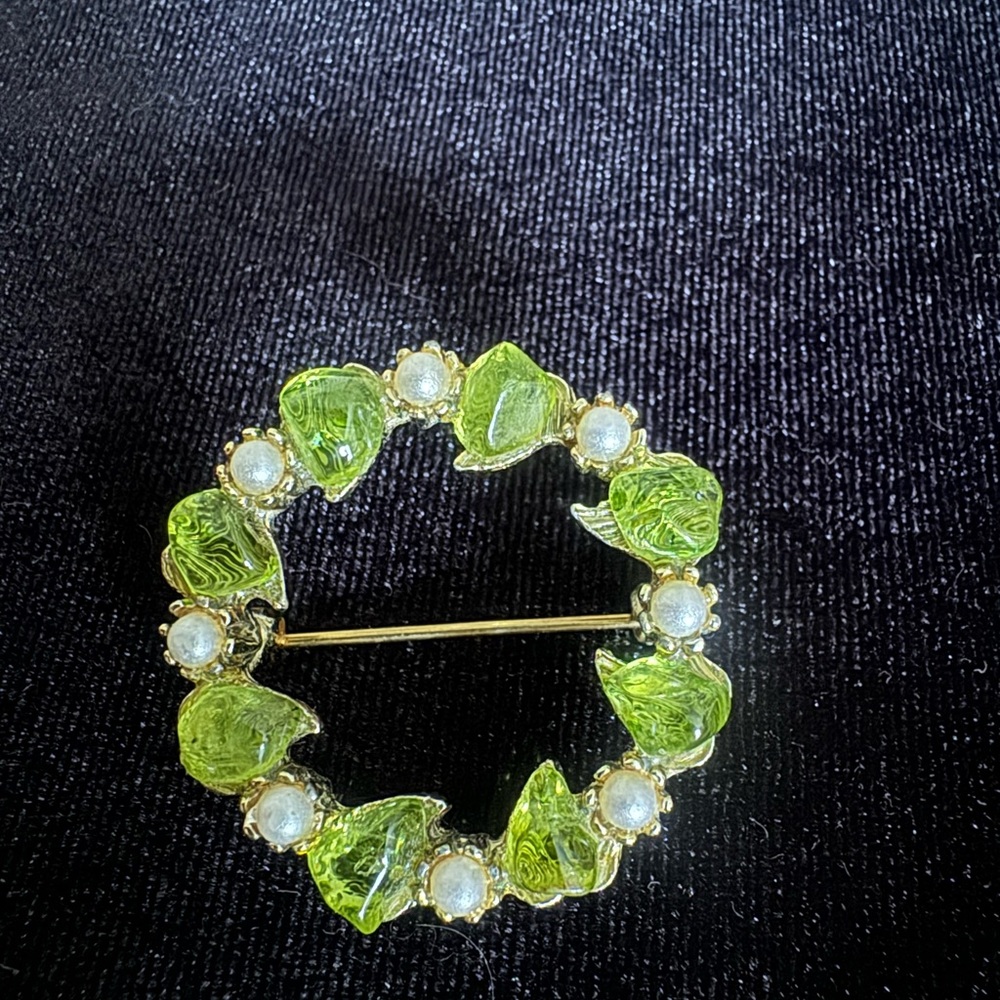 Vintage brooch featuring green acrylic, hearts, and seed pearls